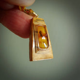 This is a hand carved woolly mammoth tusk with amber contemporary pendant. It is made from woolly mammoth tusk with amber. This is a small sized necklace and is a very unique, one only, pendant that is a collectors piece. Hand carved by New Zealand artist, Sami.